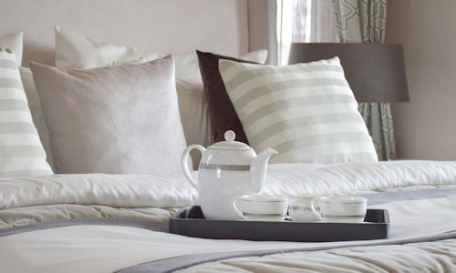 Tea tray on a made bed