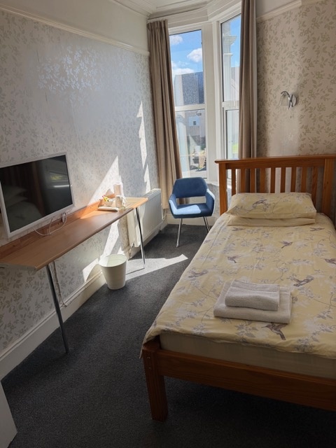 A Standard single room with a bay window, desk and television
